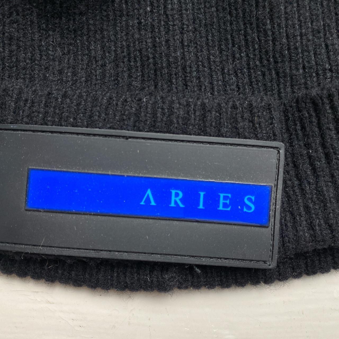 Aries Rubber Patch Black and Blue Strip Beanie Hat