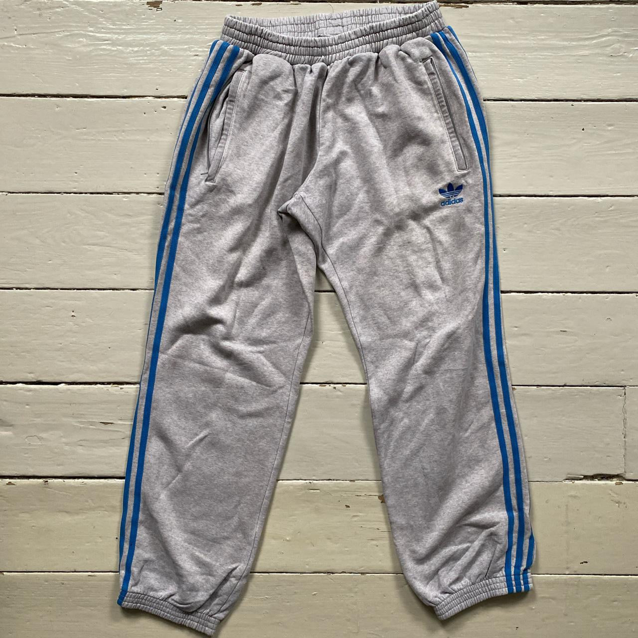 Grey adidas joggers with blue stripes sale